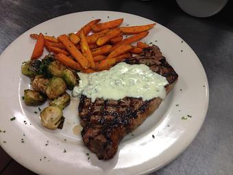 Product: New York Strip with blue cheese sauce - Sir Edmond Halley's in Myers Park - Charlotte, NC Hamburger Restaurants