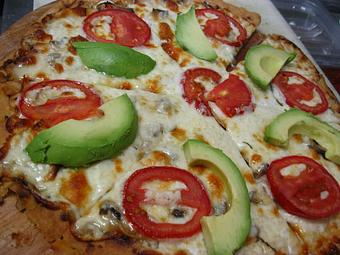 Product: Our Roasted Garlic Pizza with Roasted Garlic Cream Sauce, Mushrooms, Tomato, Basil and Avocado. - Sirens Cafe & Custom Catering in Kingman, AZ American Restaurants