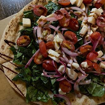 Product: grilled flatbread, balsamic tossed spinach, pickled
red onion, grape tomato, fresh mozzarella - SKYBOKX 109 Sports Bar & Grill in Across from the Natick Mall - Natick, MA American Restaurants