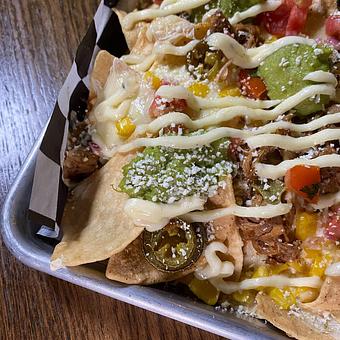 Product: braised pork, pepper jack, cotija, pico, jalapeno,
guacamole, parmesan aioli - SKYBOKX 109 Sports Bar & Grill in Across from the Natick Mall - Natick, MA American Restaurants