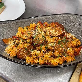 Product: Grilled Chorizo, Radiatori pasta, onions, peppers, cajun marinara sauce - SKYBOKX 109 Sports Bar & Grill in Across from the Natick Mall - Natick, MA American Restaurants