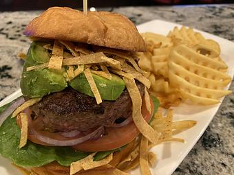 Product: half pound beef burger, sliced avocado, lettuce,
tomato, onion, tortilla crisps, brioche - SKYBOKX 109 Sports Bar & Grill in Across from the Natick Mall - Natick, MA American Restaurants