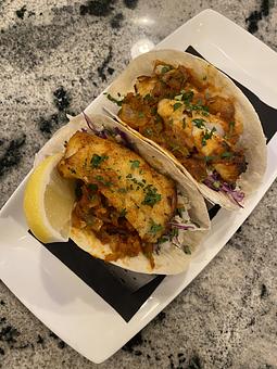 Product: two fresh atlantic cod tacos, flour tortillas, slaw,
spicy ranchero sauce - SKYBOKX 109 Sports Bar & Grill in Across from the Natick Mall - Natick, MA American Restaurants