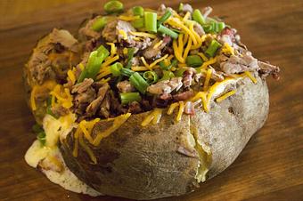 Product: Chopped Baker with Brisket, Butter, Sour Cream, Cheddar Cheese and Chives - Smokey Mo’s BBQ in New Braunfels, TX Barbecue Restaurants