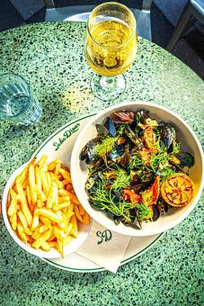 Product: Steamed PEI Mussels with lemon, white wine, tomato confit & french fries - Soho Diner in SoHo, NY - New York, NY Diner Restaurants