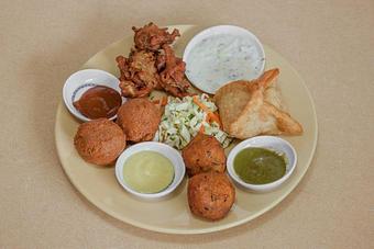 Product: Appetizer Combo Plate with falafel, butternut squash lentil cakes, samosa, veggie pakoras and zesty slaw. - Spice Restaurant in Truckee, CA American Restaurants Product: Appetizer Combo Plate with falafel, butternut squash lentil cakes, samosa, veggie pakoras and zesty slaw. - Spice Restaurant in Truckee, CA American Restaurants