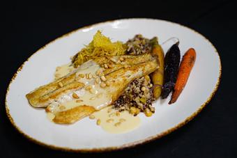 Product: Skillet Seared Barramundi Sea Bass Toasted piñón nut beurre blanc, sautéed 
rainbow carrots, spaghetti squash, caramelized onions & wild rice - Stables Ranch Grille - Restaurant-Reservations in Tubac, AZ American Restaurants