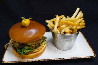 Product: Otero Burger
8 oz Angus patty, Tillamook cheddar, hatch chili aioli, caramelized onions, 
lettuce, pickles, and tomatoes - Stables Ranch Grille - Restaurant-Reservations in Tubac, AZ American Restaurants