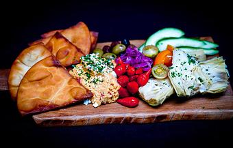 Product: Pimiento Pepper Hummus
Grilled artichokes, gastrique onions, teardrop peppers, heirloom tomatoes, cucumber, spanish olives, queso fresco and crispy pita chips - Stables Ranch Grille - Restaurant-Reservations in Tubac, AZ American Restaurants