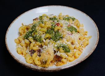 Product: Macarrones Con Chorizo 
Spanish chorizo, pimento chilies, caramelized onions, artichokes, peas, cavatappi pasta, manchego-gouda cream. Soft herb pesto breadcrumb crust - Stables Ranch Grille - Restaurant-Reservations in Tubac, AZ American Restaurants