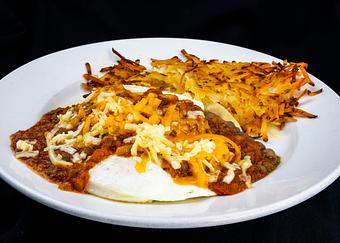 Product: Ranchero
Two eggs any style atop a corn tortilla, charro beans, chorizo, manchego, cheddar, and fresh salsa - Stables Ranch Grille - Restaurant-Reservations in Tubac, AZ American Restaurants
