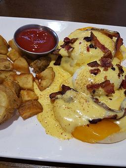 Product: Bacon and Cheddar Benedict Brunch (Hollandaise sauce, poached eggs, English muffins and house potatoes) - Station 16 in Sacramento, CA Bars & Grills