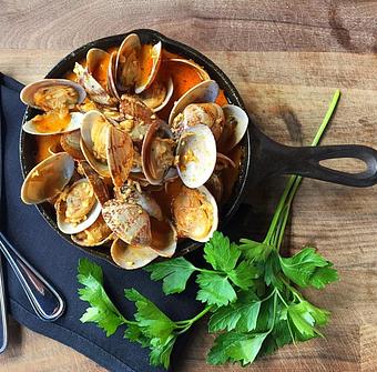 Product: Manila clams in a Cajun garlic butter broth - Station 16 in Sacramento, CA Bars & Grills
