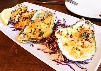 Product: Oysters on the half shell baked with mozzarella, Cajun seasoning and garlic butter - Station 16 in Sacramento, CA Bars & Grills