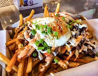 Product: Galbi Fries (Korean beef, Kimchi, and spicy aioli topped with a fried egg, green onions and sesame seeds) - Station 16 in Sacramento, CA Bars & Grills