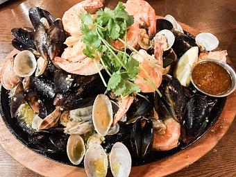 Product: Trio Mix (Prawns, mussels and clams. Serves 2-3. Temperature of skillet is hot) - Station 16 in Sacramento, CA Bars & Grills