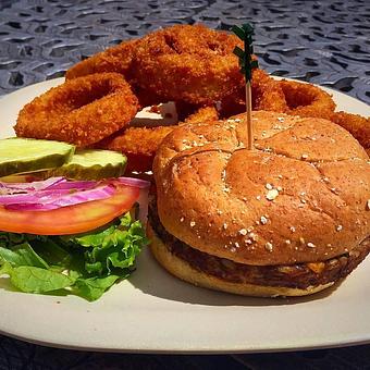 Product: Crown Cafe's veggie burger! Served with organic lettuce, tomato and onion on a wheat roll. Comes with our own Signature French Fries, Onion Rings or organic side salad. - Statue of Liberty Crown Café in New York, NY Coffee, Espresso & Tea House Restaurants