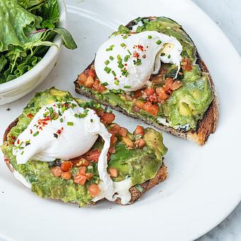 Product: hass avocado toast - tomatoes, scallion mascarpone, poached eggs, house country bread - Stella Barra Pizzeria & Wine Bar in Chicago, IL Pizza Restaurant