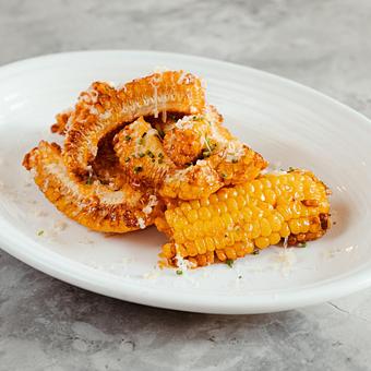 Product: Sweet Roasted Corn with spicy Calabrian aioli, chives, smoked gouda, chive, smoked gouda - Stella Barra Pizzeria & Wine Bar in Santa Monica - Santa Monica, CA Pizza Restaurant