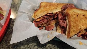 Product: 100 % All Natural Corned Beef Cut thinly sliced & Grilled Swiss Cheese with Sauerkraut Thousand Island dressing on Grilled Rye bread - Surfwiches Sandwich Shop in Jacksonville Beach - Jacksonville Beach, FL American Restaurants