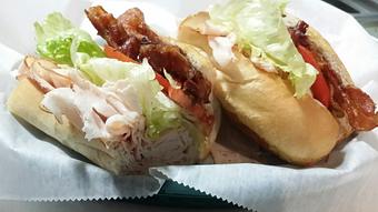 Product: 100% all Natural Turkey Breast thinly sliced & piled high, Crispy Apple-wood Smoked Bacon, Lettuce & Red ripe tomato with our Homemade Garlic Peppercorn Mayonnaise - Surfwiches Sandwich Shop in Jacksonville Beach - Jacksonville Beach, FL American Restaurants