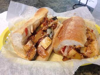 Product: Traditional Vegetarian recipe, Lightly grilled Eggplant, Zucchini, squash, bell pepper, onion then mixed with fresh tomato seasoned with Herbs DE Provence. Served with melted Provolone & Romano Cheese on a toasted Steak roll - Surfwiches Sandwich Shop in Jacksonville Beach - Jacksonville Beach, FL American Restaurants