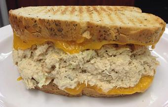 Product: 100% Solid Albacore Tuna, lettuce & tomato, S & P, oregano on Old Fashion Grilled Rye bread with melted Swiss cheese, - Surfwiches Sandwich Shop in Jacksonville Beach - Jacksonville Beach, FL American Restaurants