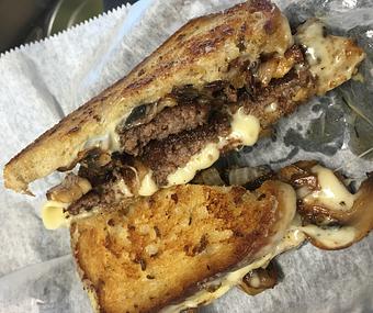 Product: Twin Angus Patties, melted Swiss cheese sauteed mushrooms & onions on grilled old fashion rye Bread - Surfwiches Sandwich Shop in Jacksonville Beach - Jacksonville Beach, FL American Restaurants