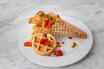 Product: Crispy chicken tenders in a big easy waffle cone. Drizzled with a spicy blend of local Steen's cane syrup and pickled jalapeños.   Tempt Restaurant - New Orleans French Quarter - Tempt in French Quarter / CBD - New Orleans, LA American Restaurants