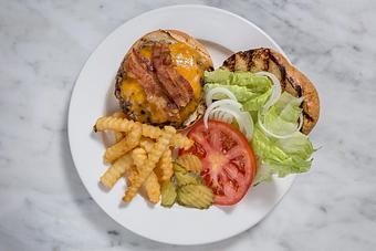 Product: 8 oz. burger dressed with lettuce & tomato and served on a Kaiser bun. Fries included.  Tempt Restaurant - New Orleans French Quarter - Tempt in French Quarter / CBD - New Orleans, LA American Restaurants