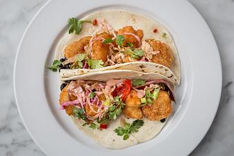 Product: Shrimp fried in a spicy Zapp's Voodoo chip batter topped with sweet chili slaw. Served on 2 flour tortillas.  Tempt Restaurant - New Orleans French Quarter - Tempt in French Quarter / CBD - New Orleans, LA American Restaurants