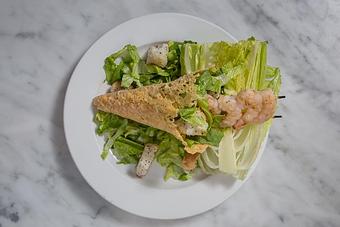 Product: Romaine lettuce with house-made Caesar dressing & garlic croutons in a Parmesan cheese waffle cone. Great on-the-go meal.   Tempt Restaurant - New Orleans French Quarter - Tempt in French Quarter / CBD - New Orleans, LA American Restaurants