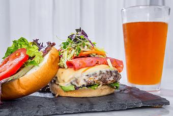 Product: 8 oz. burger dressed with lettuce & tomato and served on a Kaiser bun. Fries included. Tempt Restaurant - New Orleans French Quarter - Tempt in French Quarter / CBD - New Orleans, LA American Restaurants