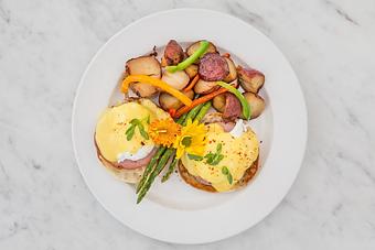 Product: Temptation Benedict - Poached eggs, Canadian bacon, Creole hollandaise with hash brown potatoes.   Tempt Restaurant - New Orleans French Quarter - Tempt in French Quarter / CBD - New Orleans, LA American Restaurants