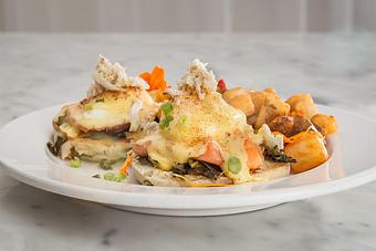 Product: Poached eggs with smoked salmon, cajun collards greens. Topped with Creole hollandaise and lump crabmeat. Served with hash brown potatoes..   Tempt Restaurant - New Orleans French Quarter - Tempt in French Quarter / CBD - New Orleans, LA American Restaurants
