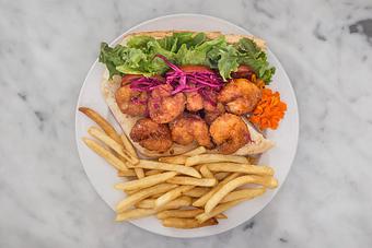 Product: Jumbo shrimp fried in a spicy Zapp's Voodoo chip batter with a sweet chili glaze. Served dressed with Tempt slaw on local French bread with fries..   Tempt Restaurant - New Orleans French Quarter - Tempt in French Quarter / CBD - New Orleans, LA American Restaurants