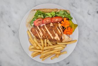 Product: Fresh catch of the day fried in a spicy Zapp's Voodoo chip batter and topped with a creole remoulade sauce. Served dressed on local French bread with fries..   Tempt Restaurant - New Orleans French Quarter - Tempt in French Quarter / CBD - New Orleans, LA American Restaurants