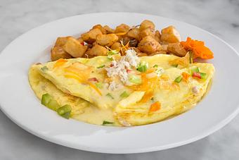 Product: Stuffed with Zapp's Voodoo chips, peppers, onions, crawfish and lump crab meat. Topped with Creole hollandaise and served with hash brown potatoes..   Tempt Restaurant - New Orleans French Quarter - Tempt in French Quarter / CBD - New Orleans, LA American Restaurants