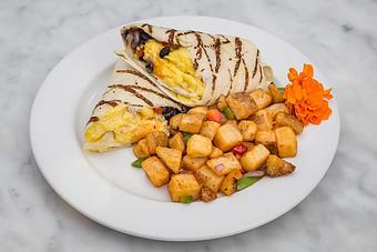 Product: Packed with scrambled eggs, peppers, onions, black beans & Cheddar cheese. Served with a side of hash brown potatoes..   Tempt Restaurant - New Orleans French Quarter - Tempt in French Quarter / CBD - New Orleans, LA American Restaurants
