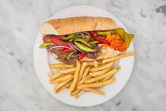 Product: Slow braised roast beef shredded and smothered in a red wine demi-glace and topped with fresh sautéed peppers and onions. Served dressed on local French bread with fries..   Tempt Restaurant - New Orleans French Quarter - Tempt in French Quarter / CBD - New Orleans, LA American Restaurants