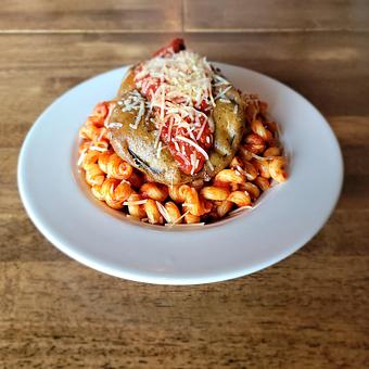 Product: Chimichurri marinated and battered eggplant, Cavatappi pasta, herbed tomato sauce topped with shaved parmesan. Served with a baguette, and choice of soup or salad. - The Acre in Albuquerque, NM American Restaurants