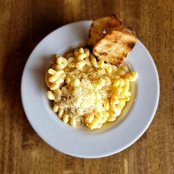 Product: Four-cheese sauce over Cavatappi pasta. Served with sauteed seasonal vegetables and sliced, grilled baguette. - The Acre in Albuquerque, NM American Restaurants