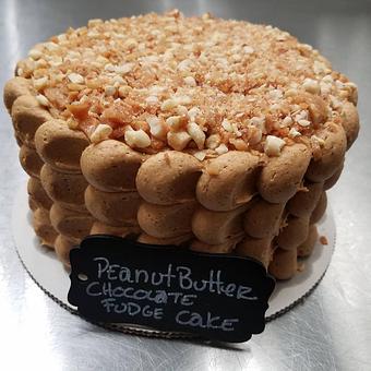 Product: One of our many scratch-made cakes.  This one is a Peanut Butter Fudge Cake.  Three layers of a moist fudge cake, peanut butter buttercream made with our homemade peanut butter and our peanut brittle crumbled on top - The Back Door Bakery & Cafe in Sunland, CA American Restaurants