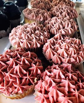 Product: Raspberry Cupcakes.  The little pound cakes are baked with fresh raspberry inside and decorated with Italian Buttercream whipped with fresh raspberries. - The Back Door Bakery & Cafe in Sunland, CA American Restaurants
