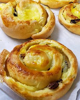 Product: Our Pain Aux Raisins pairs the classic pastry cream and raisin filling with our fluffy and lightly sweet brioche. - The Back Door Bakery & Cafe in Sunland, CA American Restaurants