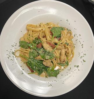 Product: Fettuccine and sliced chicken tossed in a creamy spinach and sun dried tomato sauce. - The Bowman in Parkville, MD American Restaurants
