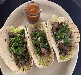 Product: 3 soft tacos filled with sliced cubed carne asada, shredded cilantro, lettuce, jalapeno, and diced onion. Served with a red salsa on the side. - The Bowman in Parkville, MD American Restaurants