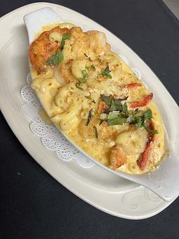 Product: Succulent scallops, shrimp and sweet lobster tossed with elbow pasta and creamy cheeses. - The Bowman in Parkville, MD American Restaurants