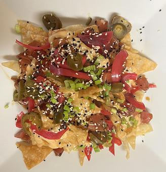 Product: Crispy wonton chips tossed with teriyaki-marinated tuna, jalapeno, pickled red onion, green onion, sesame seed, and bang bang sauce. - The Bowman in Parkville, MD American Restaurants