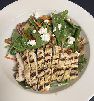 Product: Sliced chicken breast served atop a bed of spinach with goat cheese, red pepper, carrot, and walnuts; tossed in a balsamic vinaigrette. - The Bowman in Parkville, MD American Restaurants